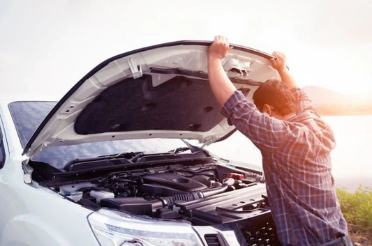 Diesel mechanic listening for engine noise with a stethoscope on a heavy-duty truck engine